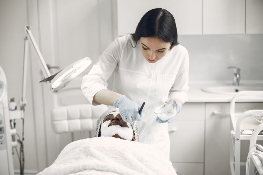 pexels photo 7446685 Woman provides facial treatment to patient in a spa setting, ensuring relaxation and care.